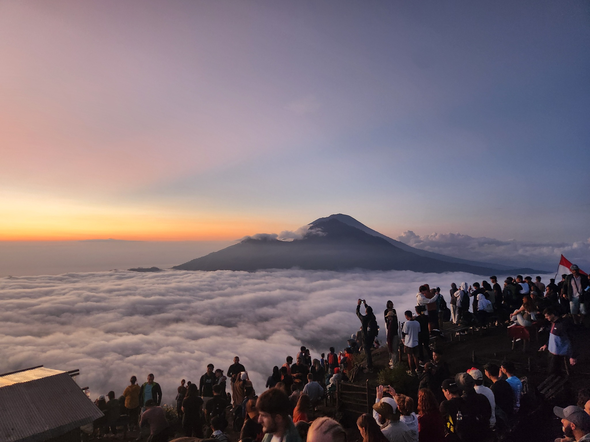 Sunrise over Mount Batur above the clouds